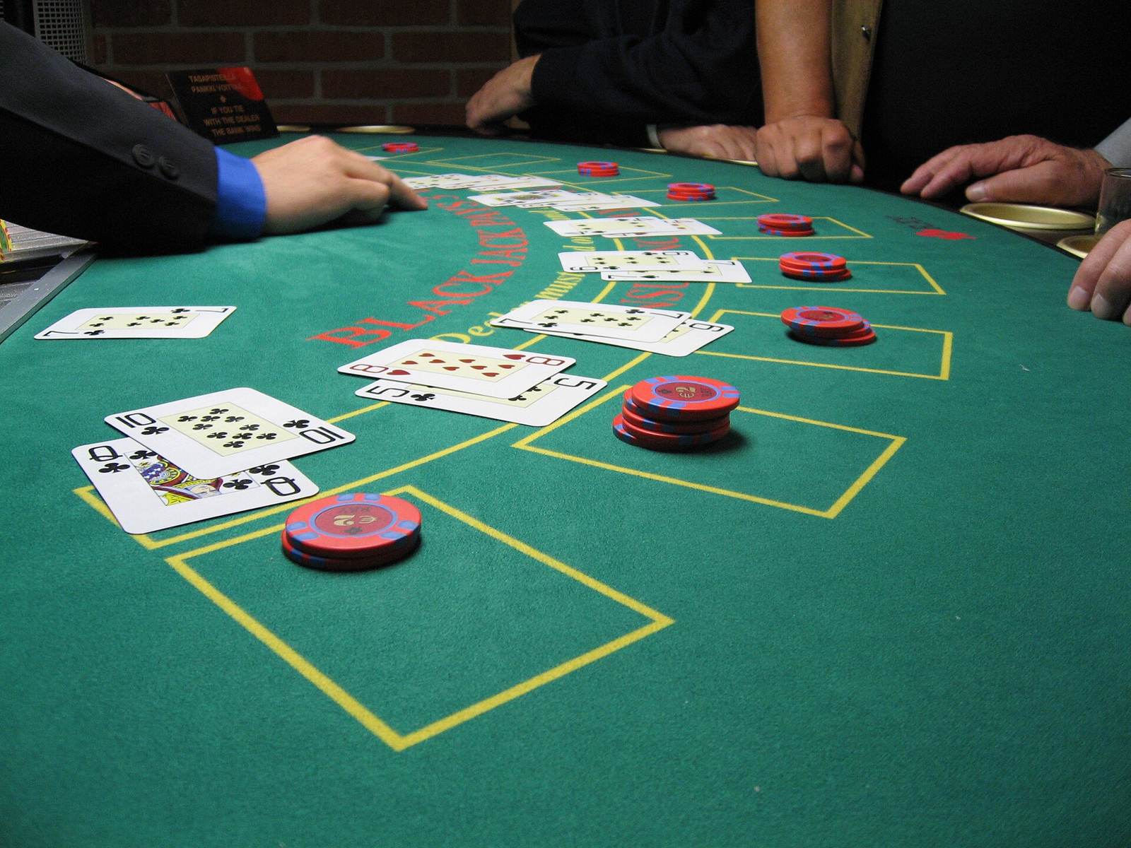 Blackjack table with cards, chips and players' hands